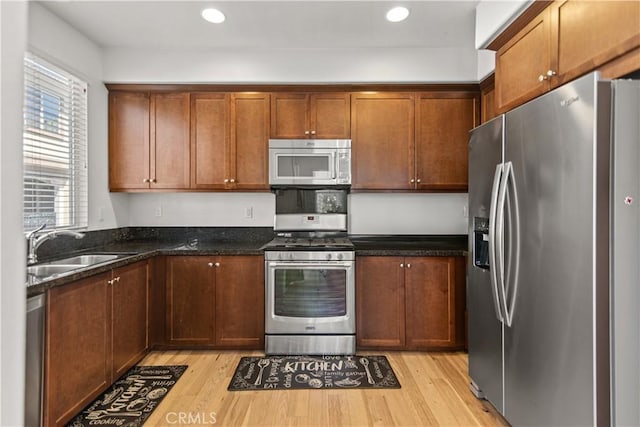 168 Royal Way, Upland, CA 91786 - kitchen featuring stainless steel appliances, light wood-style floors, dark stone countertops, and recessed lighting