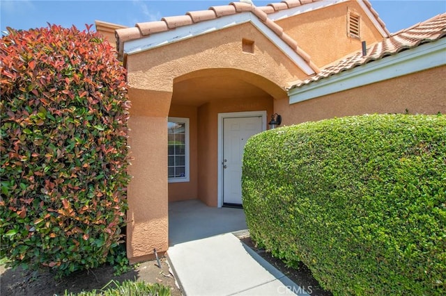 31858 Corte Priego, Temecula, CA 92592 - doorway to property featuring stucco siding and a tile roof