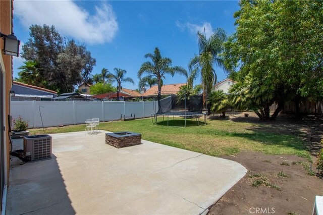 31858 Corte Priego, Temecula, CA 92592 - fenced backyard with a patio area, a trampoline, and an outdoor fire pit