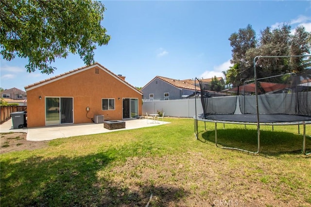 31858 Corte Priego, Temecula, CA 92592 - rear view of house featuring a trampoline, a patio, a fire pit, and a fenced backyard