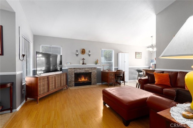 31858 Corte Priego, Temecula, CA 92592 - living room featuring wood finished floors, a chandelier, and a stone fireplace