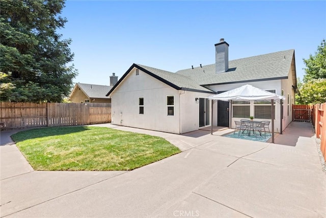 1619 Harvest Glen Dr, Chico, CA 95928 - rear view of house featuring a patio, a fenced backyard, a chimney, and stucco siding