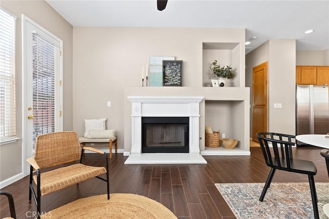 1619 Harvest Glen Dr, Chico, CA 95928 - sitting room with dark wood-type flooring, a fireplace with raised hearth, and recessed lighting