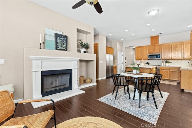 1619 Harvest Glen Dr, Chico, CA 95928 - dining room with ceiling fan, a fireplace with raised hearth, dark wood-style floors, and recessed lighting