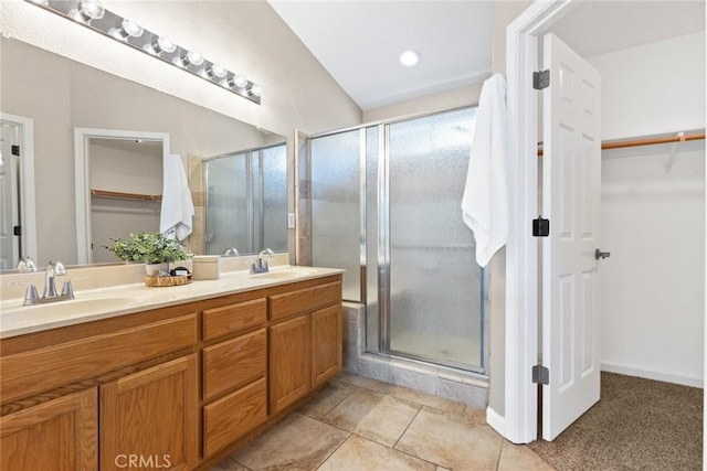 1619 Harvest Glen Dr, Chico, CA 95928 - full bathroom featuring double vanity, a walk in closet, a stall shower, and tile patterned flooring