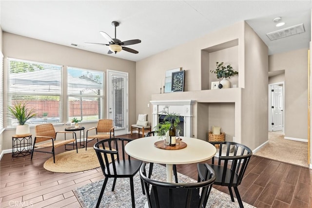 1619 Harvest Glen Dr, Chico, CA 95928 - dining area featuring dark wood-type flooring, a fireplace, and ceiling fan