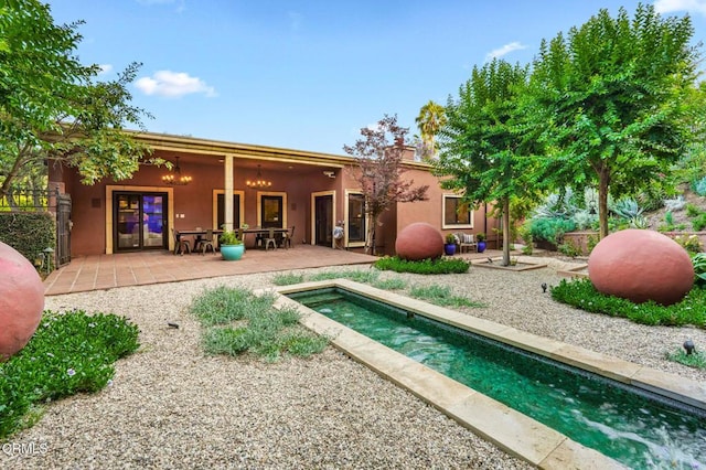 1897 Braemar Rd, Pasadena, CA 91103 - rear view of property featuring a patio, an outdoor pool, stucco siding, and a chimney