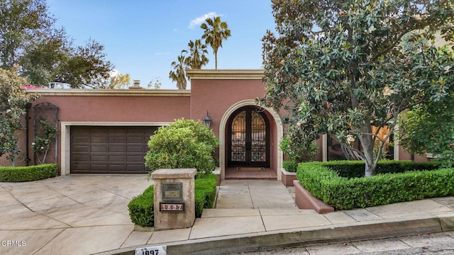 1897 Braemar Rd, Pasadena, CA 91103 - view of front of property featuring driveway, stucco siding, a garage, and french doors