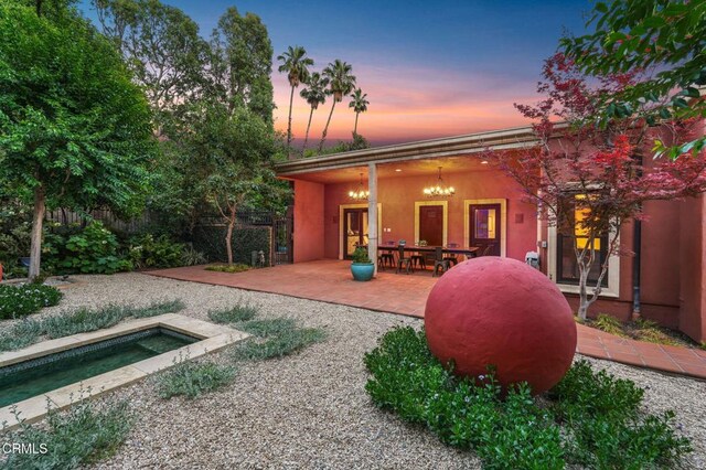 1897 Braemar Rd, Pasadena, CA 91103 - back of property at dusk with a patio, a jacuzzi, and stucco siding