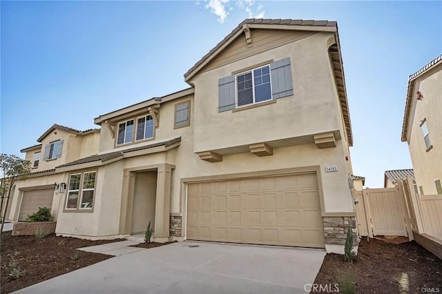 34261 Summer Ln, Yucaipa, CA 92399 - view of front facade with stucco siding, a garage, driveway, and stone siding