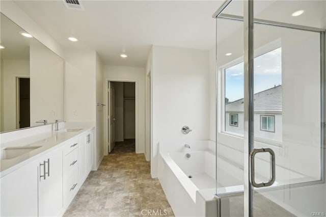 34261 Summer Ln, Yucaipa, CA 92399 - bathroom with double vanity, a bath, stone finish flooring, recessed lighting, and a shower stall