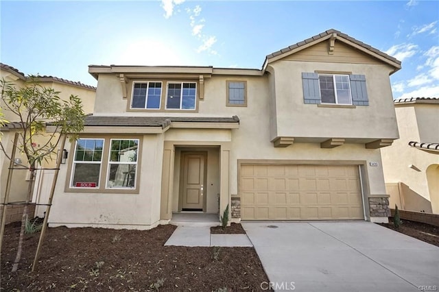 34261 Summer Ln, Yucaipa, CA 92399 - view of front of home featuring driveway, an attached garage, and stucco siding