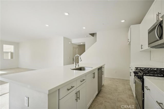34261 Summer Ln, Yucaipa, CA 92399 - kitchen featuring stainless steel appliances, white cabinets, a center island with sink, light countertops, and recessed lighting