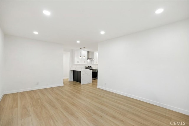 934 W Calora St, San Dimas, CA 91773 - unfurnished living room with recessed lighting and light wood-type flooring