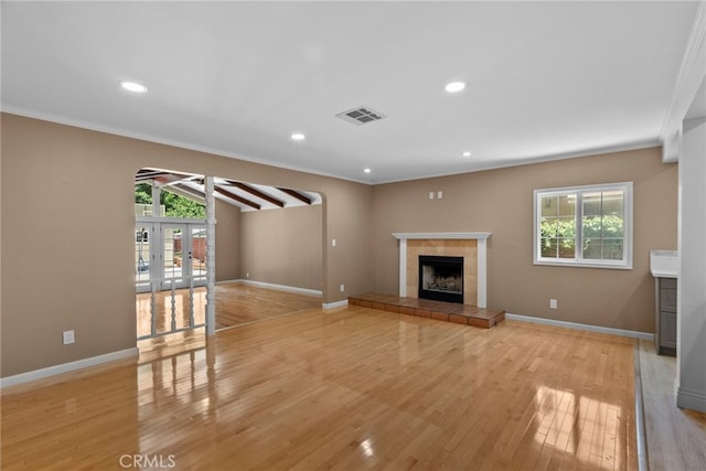 15711 Hiawatha St, Granada Hills, CA 91344 - unfurnished living room with a tile fireplace, light wood-style floors, ornamental molding, recessed lighting, and ceiling fan