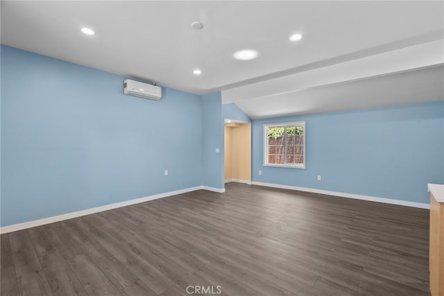 15711 Hiawatha St, Granada Hills, CA 91344 - spare room featuring an AC wall unit, dark wood-type flooring, recessed lighting, and lofted ceiling