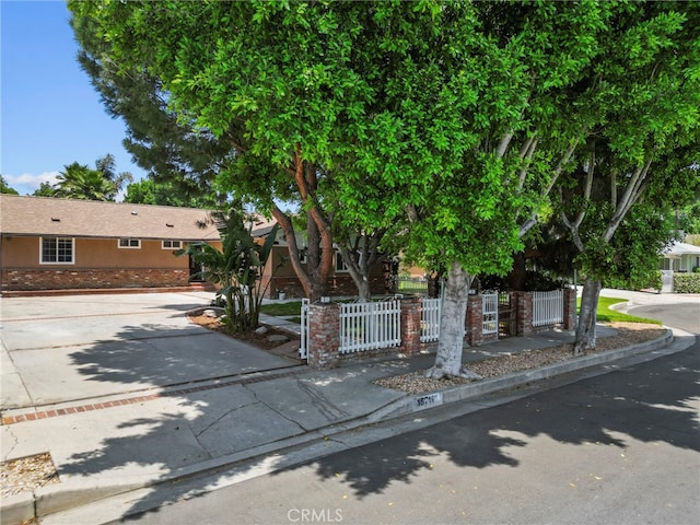15711 Hiawatha St, Granada Hills, CA 91344 - obstructed view of property featuring a fenced front yard and concrete driveway