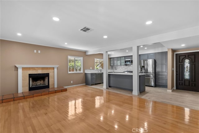 15711 Hiawatha St, Granada Hills, CA 91344 - unfurnished living room with a fireplace, light wood-style floors, recessed lighting, and ornamental molding