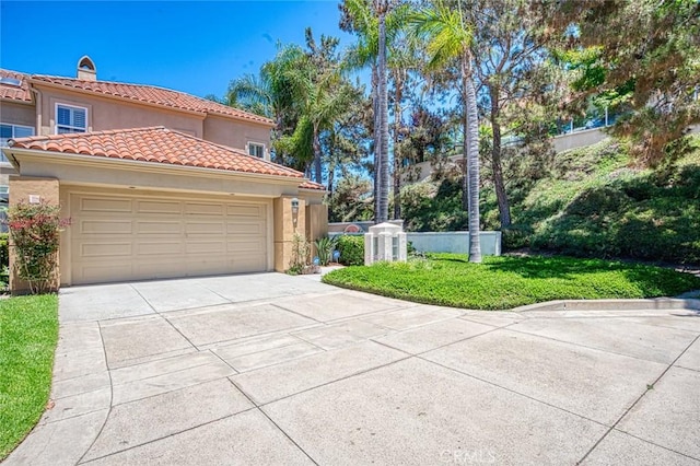 17 Siena, Laguna Niguel, CA 92677 - view of front of property featuring stucco siding, concrete driveway, a tile roof, a garage, and a chimney