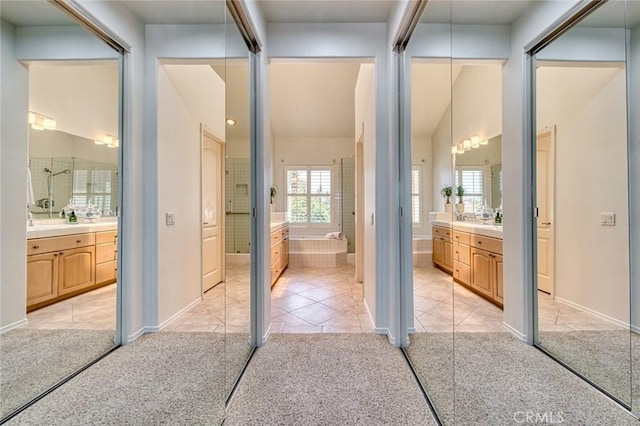 17 Siena, Laguna Niguel, CA 92677 - bathroom featuring two vanities, tile patterned flooring, and vaulted ceiling