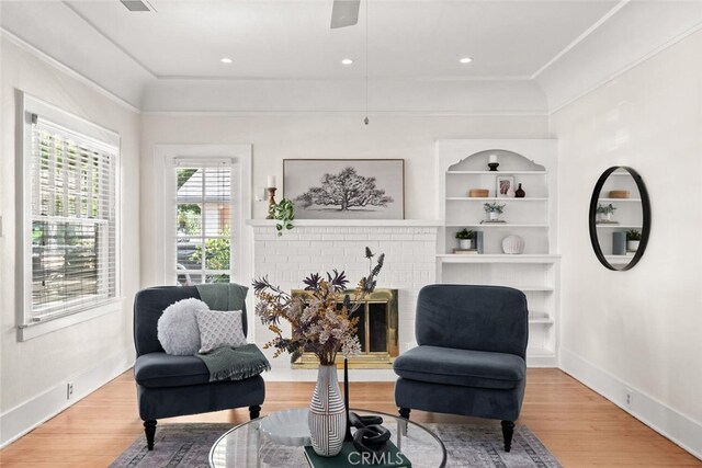 375 E 1st Ave, Chico, CA 95926 - living area featuring wood finished floors, crown molding, and a fireplace