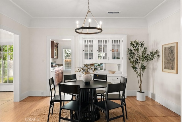 375 E 1st Ave, Chico, CA 95926 - dining space with a chandelier, light wood finished floors, and crown molding