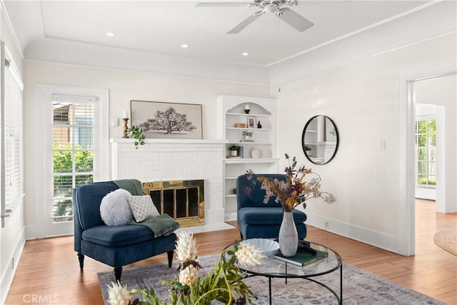 375 E 1st Ave, Chico, CA 95926 - living area with healthy amount of natural light, light wood-type flooring, a ceiling fan, a fireplace, and crown molding