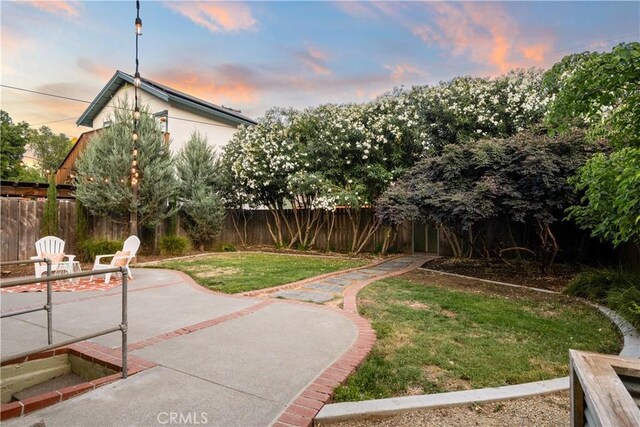 375 E 1st Ave, Chico, CA 95926 - yard at dusk featuring a patio and a fenced backyard