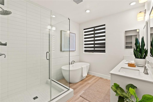 27636 S Evergreen Pl, San Pedro, CA 90732 - full bath featuring a stall shower, wood finished floors, double vanity, a freestanding bath, and recessed lighting