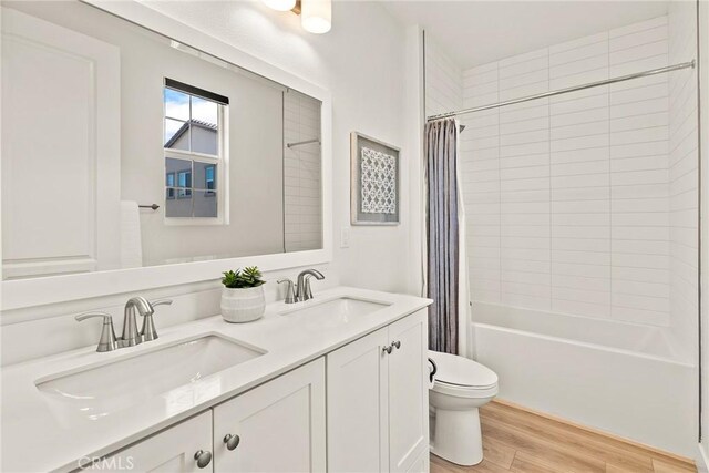 27636 S Evergreen Pl, San Pedro, CA 90732 - bathroom with double vanity, wood finished floors, and shower / bath combo