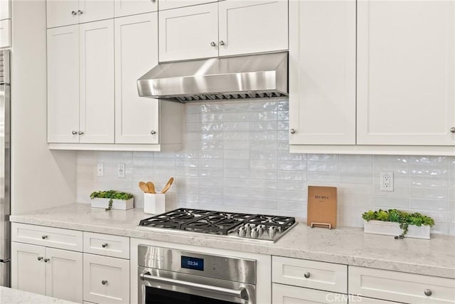 27636 S Evergreen Pl, San Pedro, CA 90732 - kitchen with appliances with stainless steel finishes, wall chimney exhaust hood, white cabinetry, and decorative backsplash