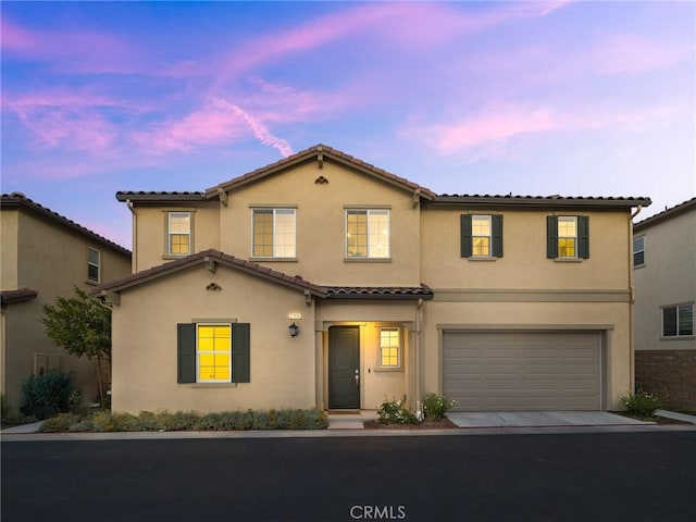 27636 S Evergreen Pl, San Pedro, CA 90732 - view of front facade with stucco siding, an attached garage, and a tile roof