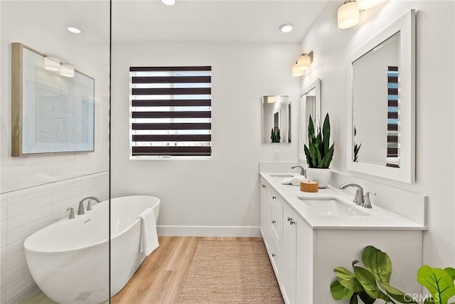 27636 S Evergreen Pl, San Pedro, CA 90732 - bathroom with a freestanding bath, double vanity, wood finished floors, and recessed lighting