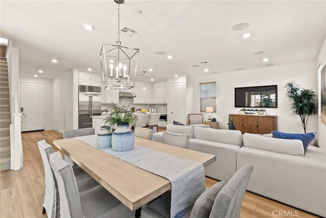 27636 S Evergreen Pl, San Pedro, CA 90732 - dining space featuring recessed lighting, light wood-style floors, a chandelier, and stairs