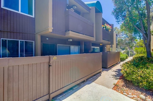 3454 Castle Glen Dr Unit 115, San Diego, CA 92123 - view of home's exterior with a balcony and a gate