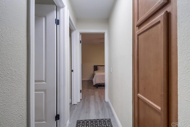 3454 Castle Glen Dr Unit 115, San Diego, CA 92123 - corridor featuring light wood-style flooring and a textured wall