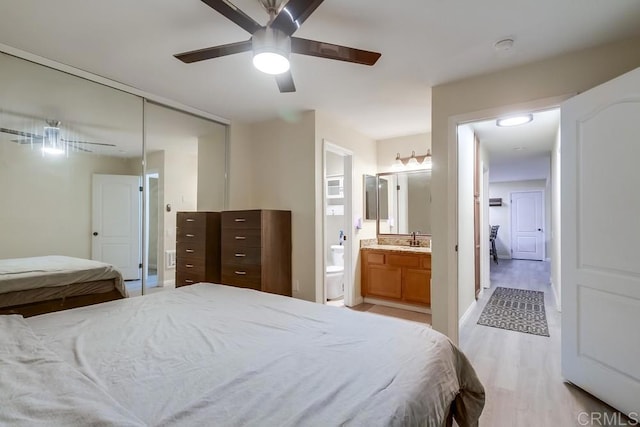 3454 Castle Glen Dr Unit 115, San Diego, CA 92123 - bedroom with a closet, light wood-type flooring, ensuite bathroom, and ceiling fan