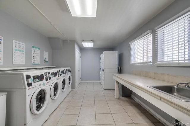 3454 Castle Glen Dr Unit 115, San Diego, CA 92123 - communal laundry room featuring washer and dryer and light tile patterned flooring