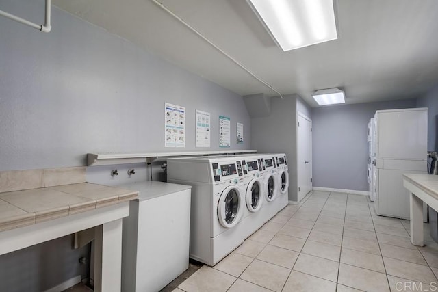 3454 Castle Glen Dr Unit 115, San Diego, CA 92123 - community laundry room with stacked washing machine and dryer, washer and dryer, and light tile patterned flooring