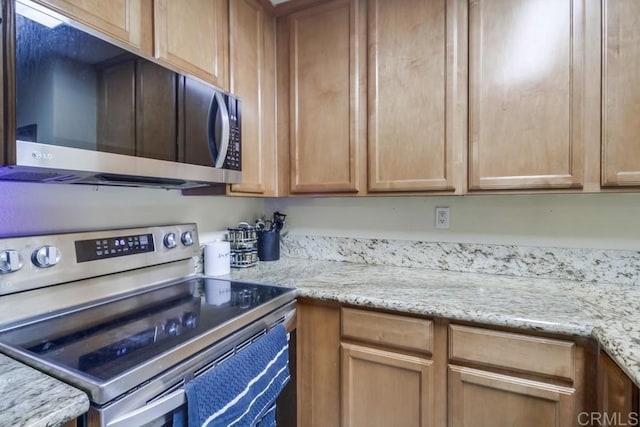 3454 Castle Glen Dr Unit 115, San Diego, CA 92123 - kitchen with appliances with stainless steel finishes and light stone countertops