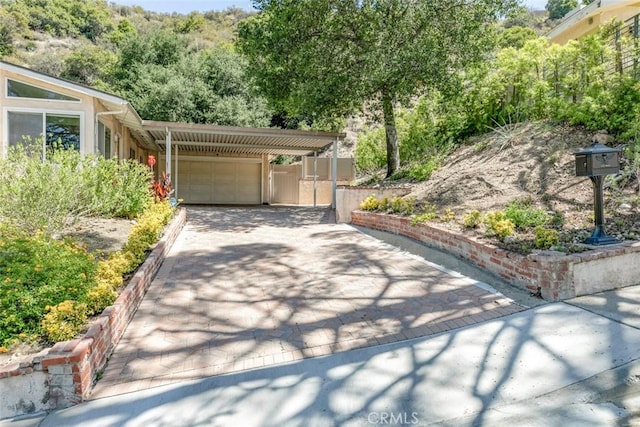10919 Terecita Rd, Tujunga, CA 91042 - garage with concrete driveway and an attached carport