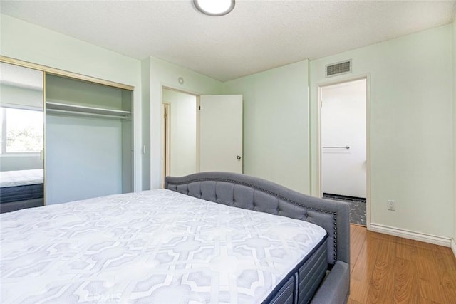 10919 Terecita Rd, Tujunga, CA 91042 - bedroom with wood finished floors, a closet, and a textured ceiling