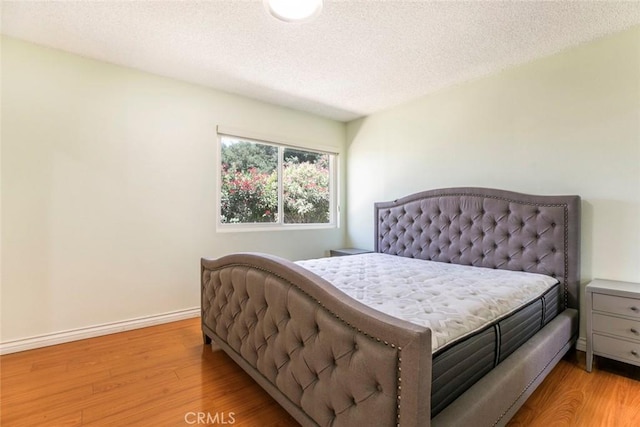 10919 Terecita Rd, Tujunga, CA 91042 - bedroom featuring light wood finished floors and a textured ceiling