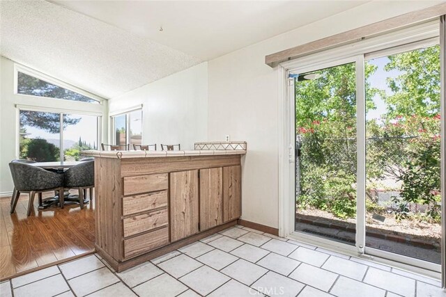 10919 Terecita Rd, Tujunga, CA 91042 - bathroom featuring lofted ceiling, tile patterned floors, and a textured ceiling