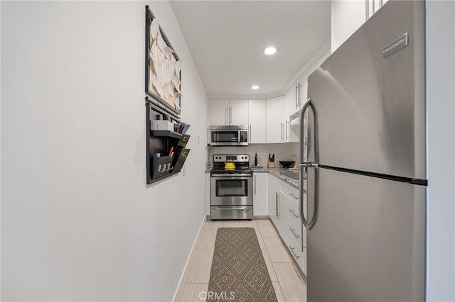 2825 N Los Felices Rd Unit 211, Palm Springs, CA 92262 - kitchen with stainless steel appliances, white cabinets, recessed lighting, and light stone counters