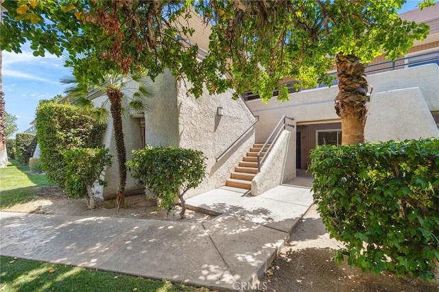 2825 N Los Felices Rd Unit 211, Palm Springs, CA 92262 - view of front facade featuring stucco siding and stairs