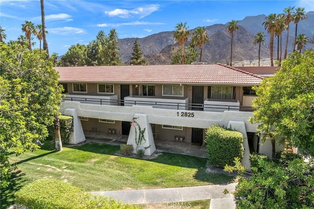 2825 N Los Felices Rd Unit 211, Palm Springs, CA 92262 - view of front of house featuring a mountain view, a tile roof, and a balcony