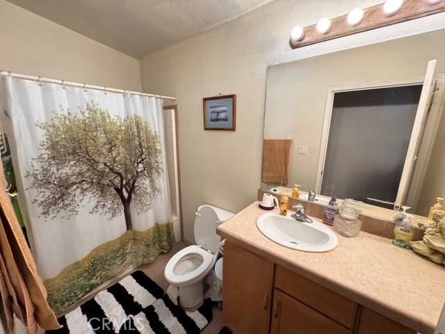 6475 105th St W, Rosamond, CA 93560 - bathroom featuring vanity and a shower with curtain