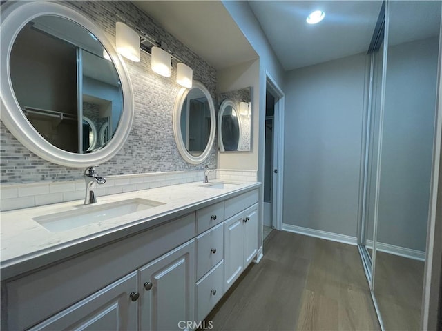 21520 Burbank Blvd Unit 116, Woodland Hills, CA 91367 - full bathroom featuring decorative backsplash, wood finished floors, and double vanity
