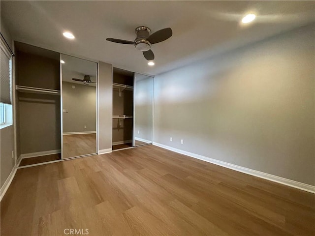 21520 Burbank Blvd Unit 116, Woodland Hills, CA 91367 - unfurnished bedroom featuring multiple closets, wood finished floors, recessed lighting, and a ceiling fan